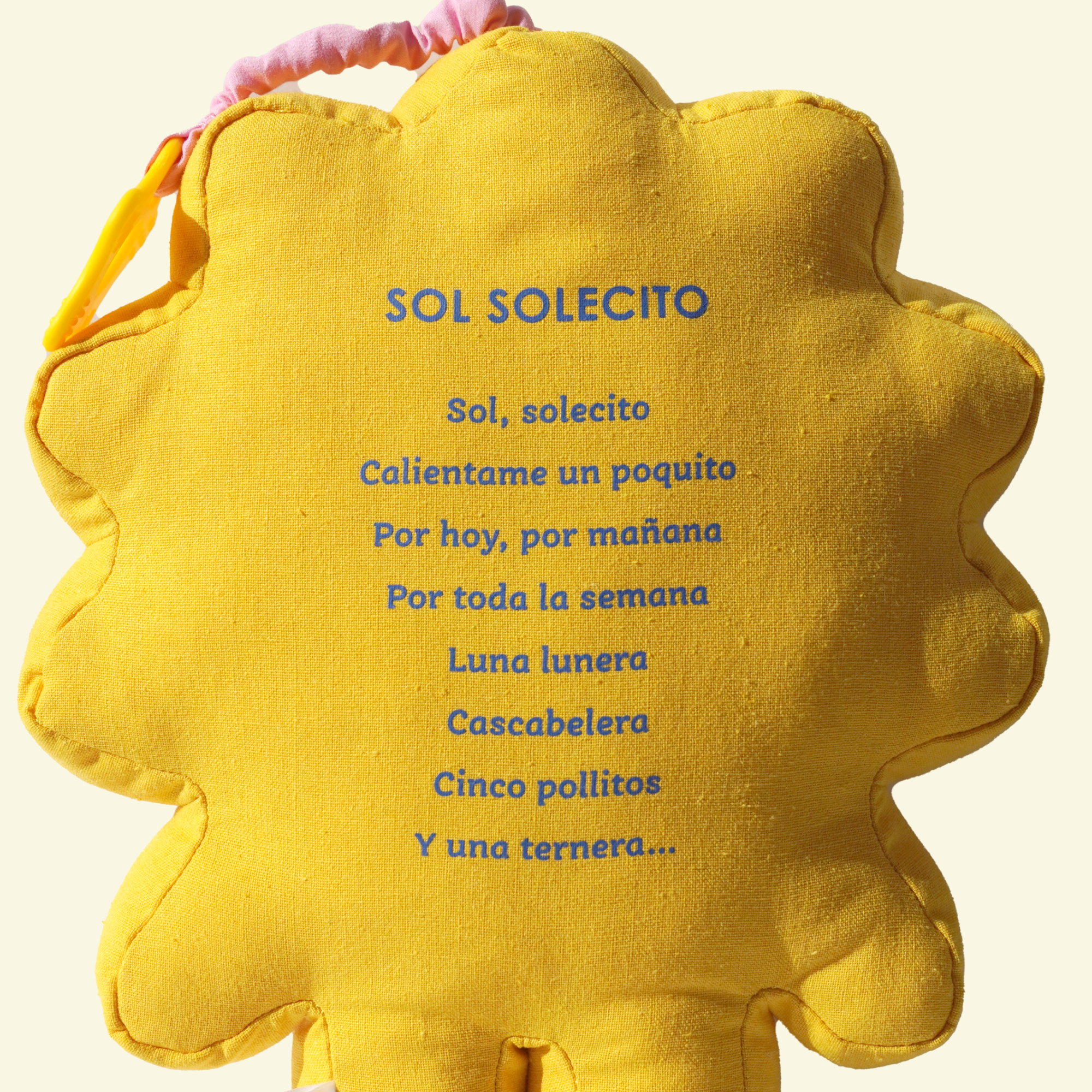 Yellow plush toy with Sol Solecito's lyrics printed on the back on a light beige background